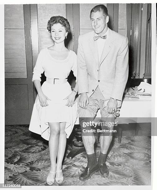 Actress Mitzi Gaynor and Los Angeles Rams' football star Elroy "Crazylegs" Hirsch display legs which are well known for different reasons. Mitzi and...