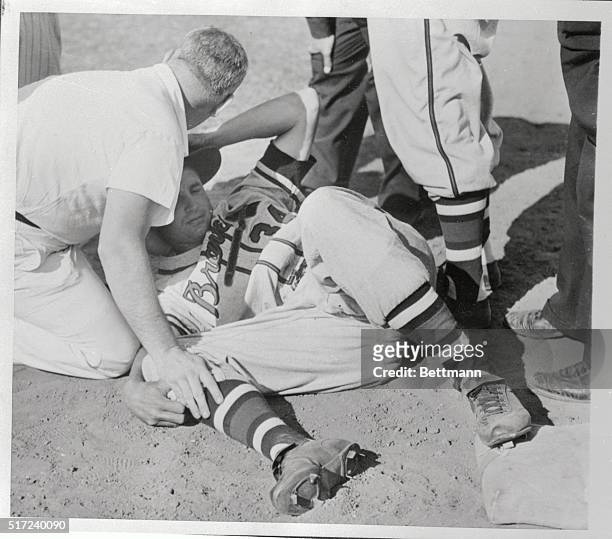 Outfielder Bobby Thomson lies on the ground after suffering a triple fracture of his right ankle here on March 13th, while attempting to slide into...