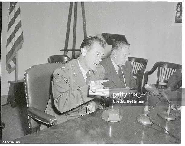 Speed King. Washington: Maj. Charles E. Yeager , and Lawrence Bell, president of Bell Aircraft Corp., look at model of the Bell X-IA rocket plane in...