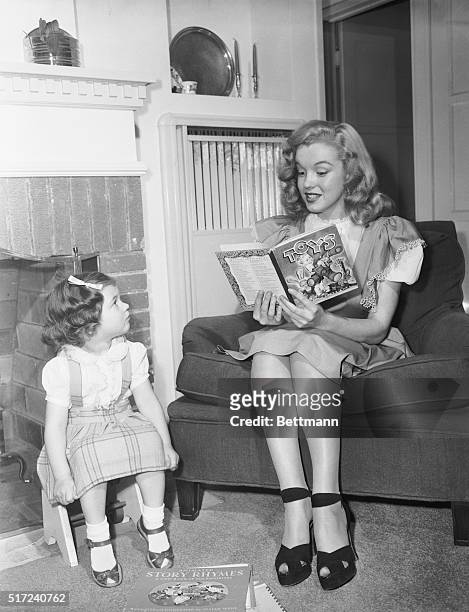 Lovely Marilyn Monroe, former baby sitter now turned actress, proves that she hasn't lost any of her appeal for children. Marilyn landed a contract...
