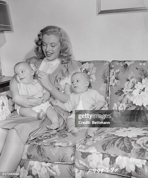 Shown "brushing up on her home work" is cute 18-year-old Marilyn Monroe. Marilyn is a former "baby sitter" who got the break of her life through that...