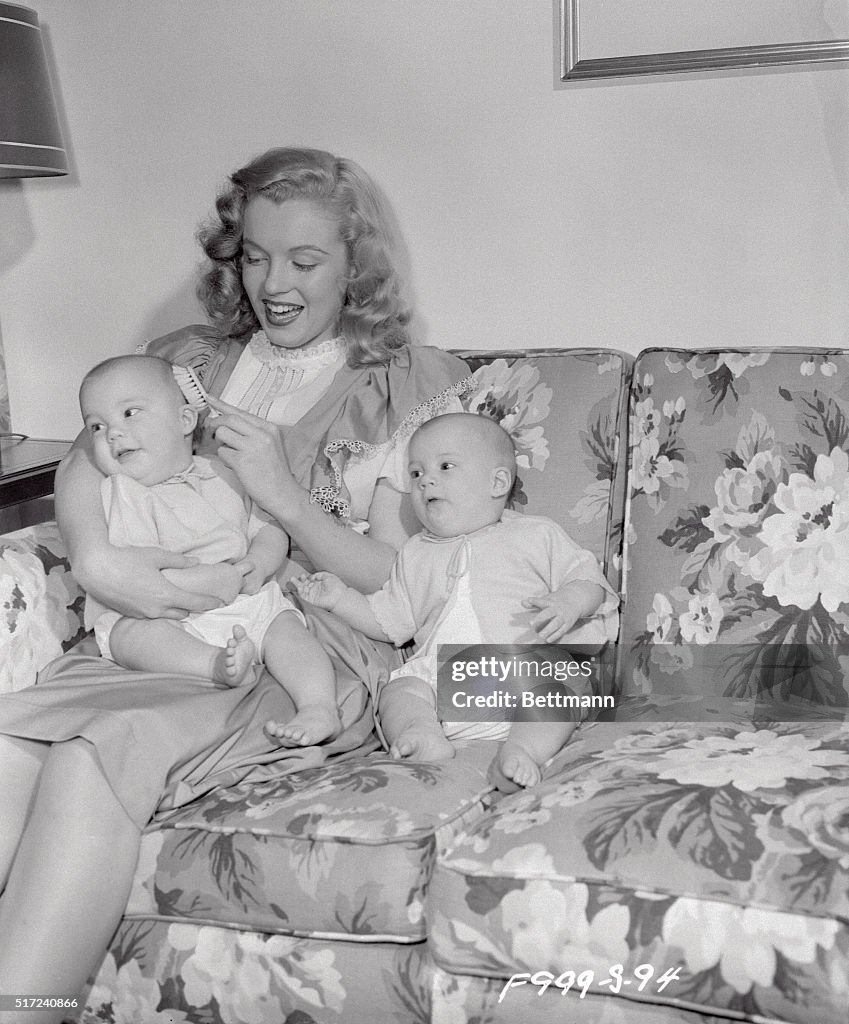 Marilyn Monroe Sitting on Couch with Babies