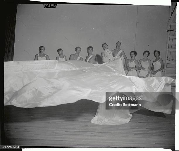 Flailing long flowing veils for which she is remembered, ballerina Ruth St. Denis is seen as she rehearses with members of her dance troupe for the...
