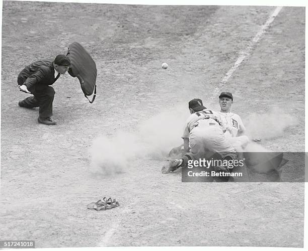 Tiger Jim Delsing scores from 1st base on Ray Boone's double to left field during the 6th inning of Detroit-Chicago game. Bad throw to plate got away...