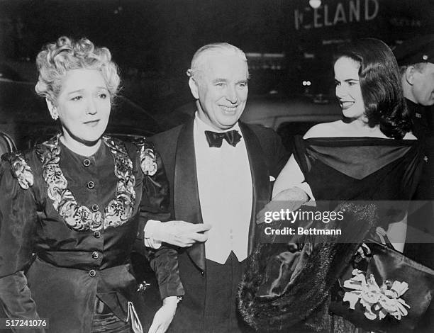 At Premiere of New Chaplin Picture. New York, New York: Mary Pickford is shown with Mr. And Mrs. Chaplin as they attended the premiere of Chaplin's...