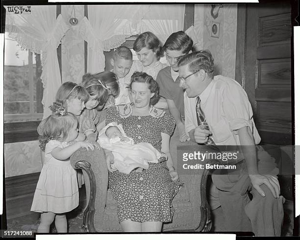 Mrs. Margaret Thommes shows her children their new baby sister, Joan Frances, 7 days old, who is her ninth consecutive Caesarean section baby. Mrs....