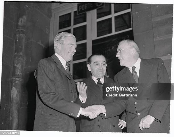 Secretary of State John Foster Dulles is greeted by British Foreign Secretary Anthony Eden and French Premier Pierre Mendes- France prior to their...