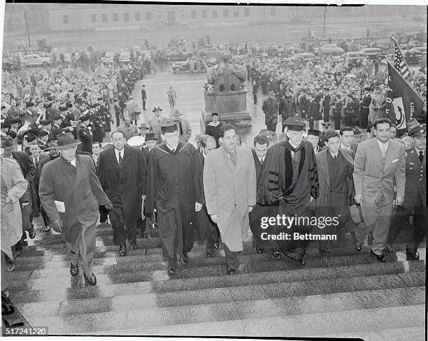 Mexican President at Columbia for Degree. New York: President Miguel Aleman of Mexico is escorted up the steps of Low Memorial Library at Columbia...