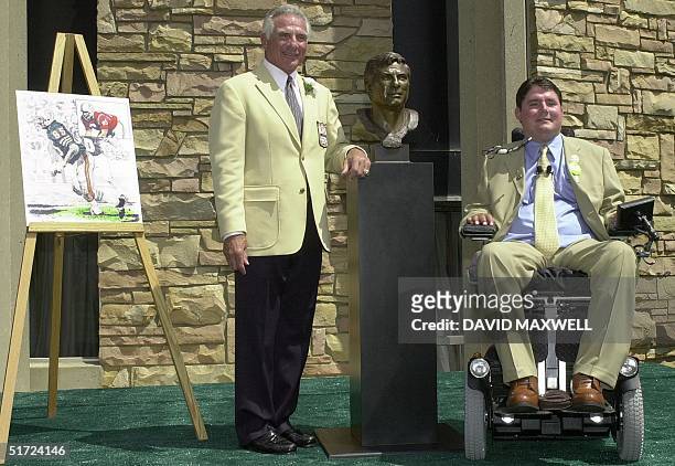 Pro Football Hall of Fame enshrinee Nick Buoniconti and his son and presenter Marc Buoniconti pose with Nick's bust during the enshrinement ceremony...