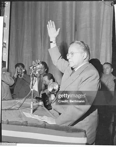 Hand raised, Italian Communist leader Palmiro Togliatti speaks from the rostrum to his party followers convened in great number to the annual...