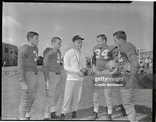 Terry Brennan , starting his first season as coach of Notre Dame's "Fighting Irish," talks with four of last season's starters at the opening...