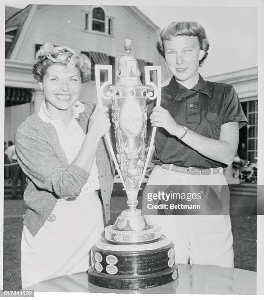Both finalists in the Women's Amateur Golf Tournament display smiles of confidence as they grasp the trophy which one of them will win when they meet...