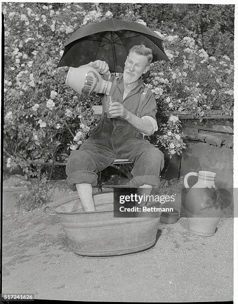 With a gleam in his eye, a Frankfurt fisherman smacks his lips as he views the cool liquid, apple jack, running into his glass, while a happy...