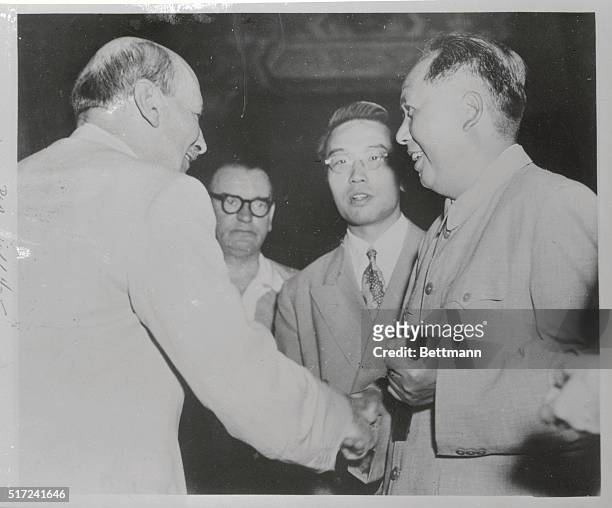 The famous though mysterious chairman of the Central People's Government of the People's Republic of China, Mao Tse-Tung , greets Clement R. Attlee ,...