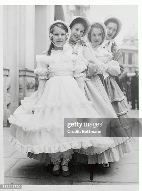 Dressed in crinoline costumes, four pretty young London ladies prepare to portray daughters of Britain's Queen Victoria at the Drury Lane Theater....