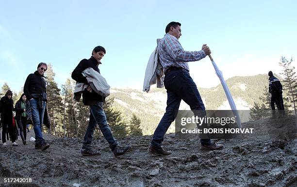 Relatives and friends of victims walk on the Col in Le Vernet, southwestern France, on March 24 in front of the mountain were the plane of...