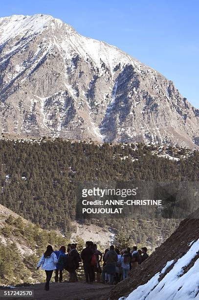 Relatives of victims walk on the Col Mariaud in Le Vernet, southwestern France, on March 24 in front of the mountain were the plane of Germanwings...