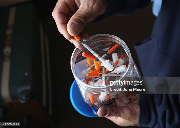 Drug user takes a needle before injecting himself with heroin on March 23, 2016 in New London, CT. Communities throughout New England and nationwide...