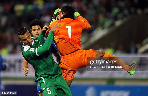 Thailand's goalkeeper Kawin Thamsatchanan holds onto the ball ahead of Iraq's Ali Adnan during their 2018 World Cup qualifying football match at...