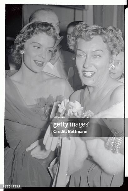 Arrayed in furs and sparklers, actress Gloria Swanson chats animatedly with her beautiful daughter Michele Farmer, at the fifteenth International...