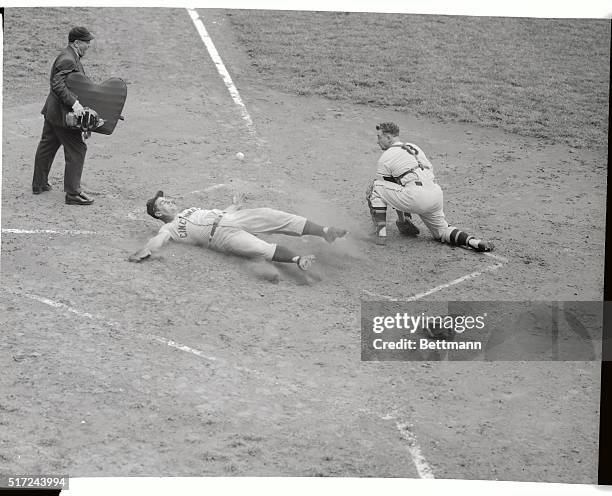 It's an error for Giant catcher Ray Katt , as the ball bounds away and Cincinnati slugger Ted Kluszewski slides in almost flat on his back to score a...