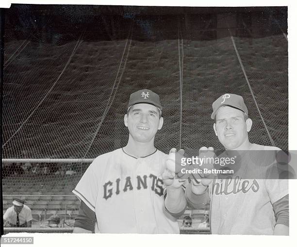Couple of 18 game winners show how to clutch a baseball for mound work, at the Polo Grounds. Johnny Antonelli of the Giants and Robin Roberts of the...