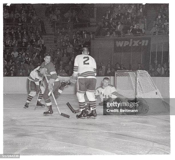 From his stance it would be easy to assume that Detroit Red Wings' forward Ted Lindsay is a bit irked as New York Rangers' goalie Lorne Worsley...