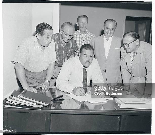 Former heavyweight champion Joe Louis signs a contract purchasing part interest in Las Vegas' $3 000 Moulin Rouge Hotel, which is now under...