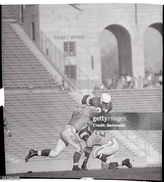 Chicago Cards Halfback Emmett King is stopped by Los Angeles Rams Guard Les Richter and Halfback Woodley Lewis , during the second quarter of their...