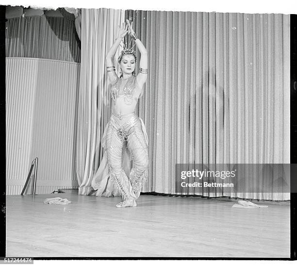 Wearing a 60 pound gold chain costume on her 110 pound body, actress Debra Paget prepares for her opening at a Las Vegas nightclub. She will perform...