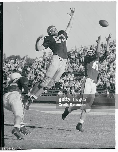 James Owen of the Navy jumps high in an unsuccessful attempt to intercept a Stanford pass to Gus Gustafson during the Navy-Stanford football battle...