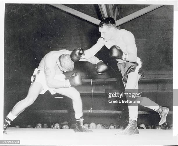 Gene Fullmer , Utah middleweight, lands a right to the head of Jackie La Bua in the fourth round of their bout. Fullmer scored an upset.