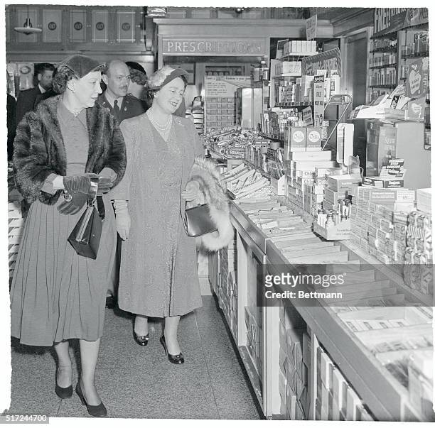 Mrs. Dwight Eisenhower takes Queen Mother Elizabeth through a drug store in the Pentagon building November 6th during their sightseeing tour of the...