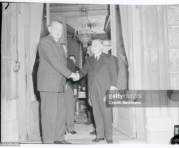 Japan's Prime Minister Shigeru Yoshida shakes hands with French President Rene Coty. Yoshida touring France for the first time paid a courtesy visit...