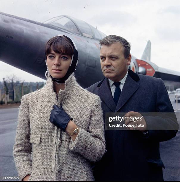 English actor Patrick Wymark posed with actress Wendy Gifford in front of the Scott-Furlong Predator VTOL aircraft from the television series 'The...