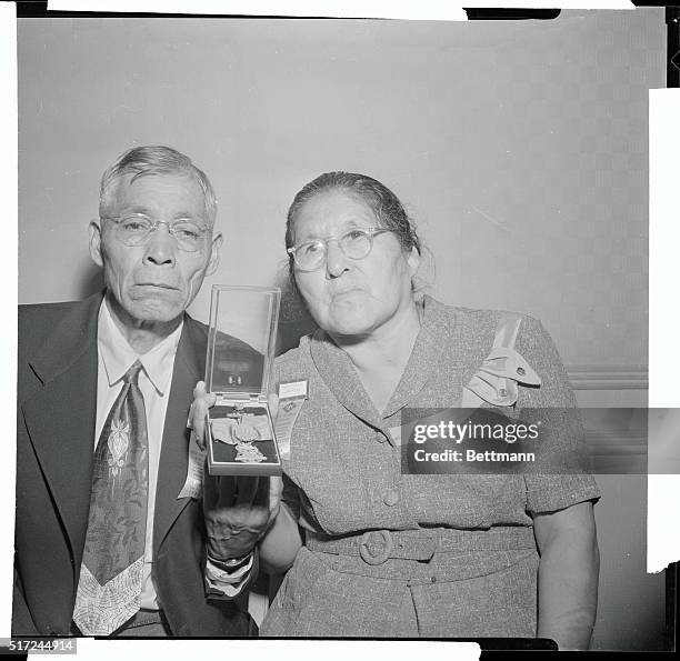 Mr. And Mrs. Jacob George of the Cherokee Indian reservation in North Carolina, proudly hold the Congressional Medal of Honor which was awarded...