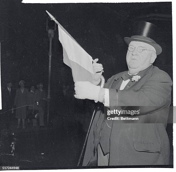 Buyer for Northern Ireland. London, England: John J. Hanley, the Irish-American millionaire "Baron of Broadway" holds up an Irish flag in London,...
