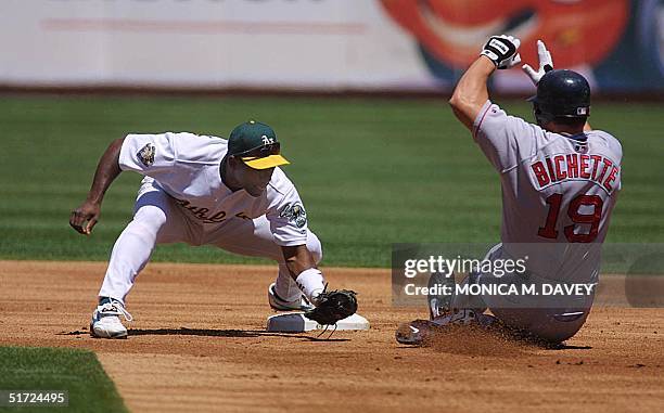 Oakland Athletics' Miguel Tejada waits for Boston Red Sox's Dante Bichette at second base after Bichette tried to stretch a single into a double in...