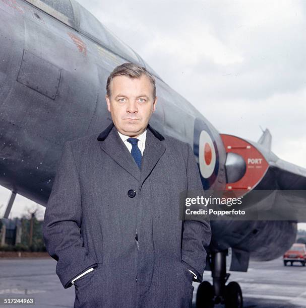 English actor Patrick Wymark in front of the Scott-Furlong Predator VTOL aircraft from the television series 'The Plane Makers' in 1964.