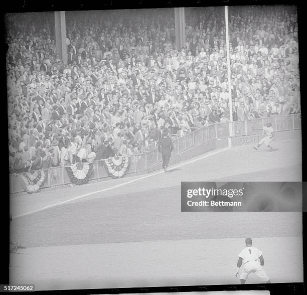 Goes for Double. New York, New York: Dodgers' left fielder Sandy Amoros makes a running one-handed catch of Yogi Berra's long fly ball along the left...
