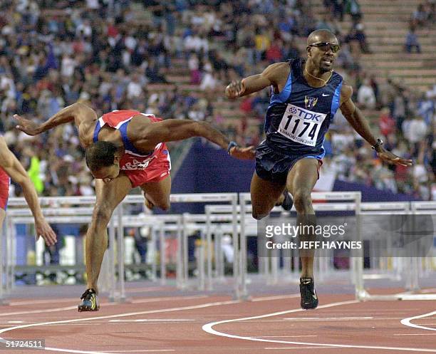 Allen Johnson of the US wins the men's 110M hurdles final ahead of Anier Garcia of Cuba at the 8th World Championships in Athletics 09 August 2001 in...