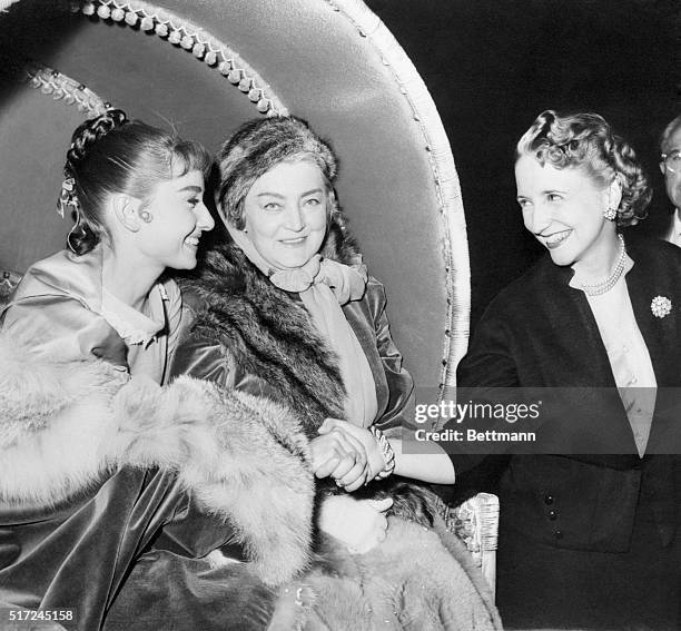 From her horse-drawn carriage, lovely screen star Audrey Hepburn greets Margaret Truman, daughter of the former U.S. President, during the latter's...