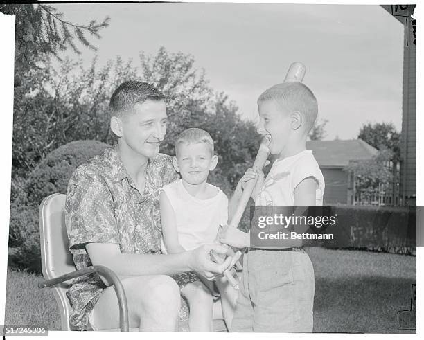 Chicago White Sox pitcher Dick Donovan offers batting tips to his nephew, Bobby Kelley while 4 year old Jimmy likewise a nephew, watches. Dick,...