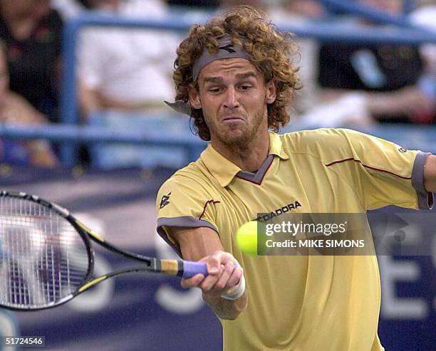 Gustavo Kuerten of Brazil uses a forehand against Yevgeny Kafelnikov of Russia in the quarterfinals of the Tennis Masters Series 10 August 2001 in...