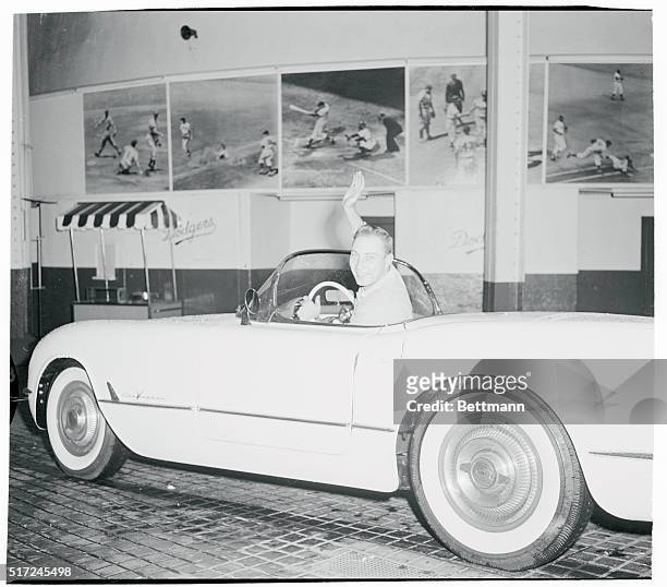 Plenty of Drive. New York, New York: 1955 World Series hero, Johnny Podres, Brooklyn Dodgers' pitcher, waves as his sits behind the wheel of a 1955...