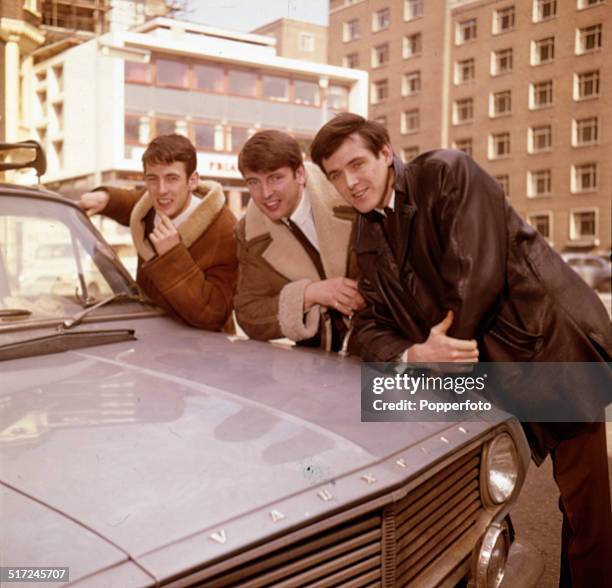 Declan Cluskey, Conleth Cluskey and John Stokes of Irish vocal group The Bachelors pictured beside a Vauxhall car in London in 1964.