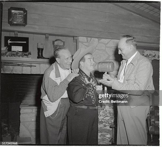 His sidekick, Bud Abbott, looks on as Lou Costello accepts a gavel after being named honorary mayor of Canoga Park, California. The new mayor's first...