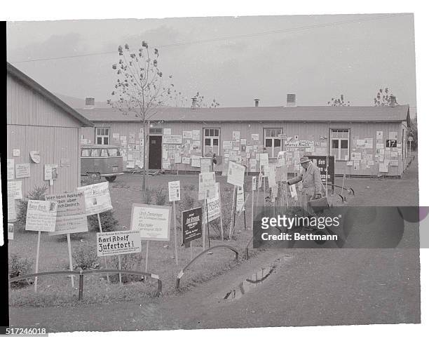 Garden of Missing Persons. Friedland, Germany: Pleas for held sprout like flowers and plaster the walls at the Friedland prisoner repatriation camp...