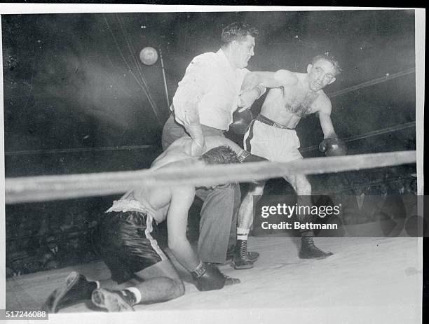 Carmen Basilio is pushed away by referee Mel Manning after successfully defending his welterweight title with a technical knockout in the 12th round...