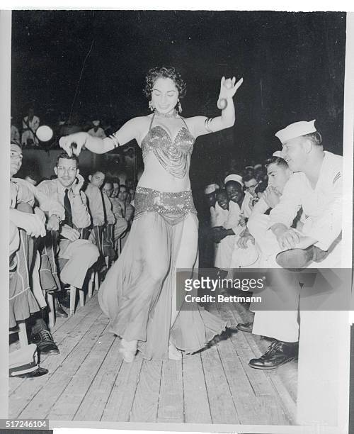 Lebanese Rock and Roll? Beirut, Lebanon: A belly dancer from a group of Beirut performers delights personnel aboard the heavy cruiser USS Des Moines...